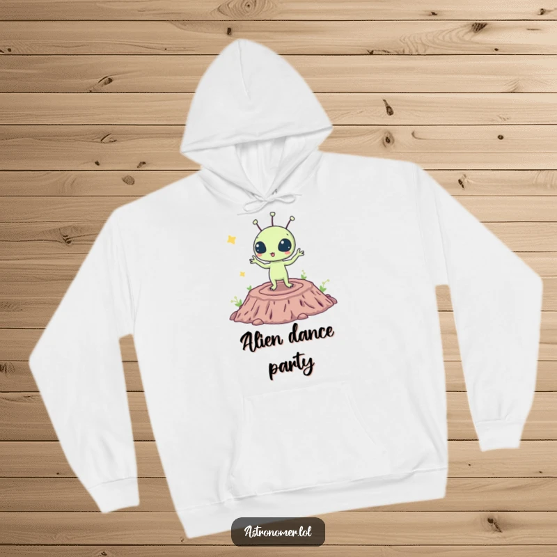 Funny hoodie featuring a surprised alien creature busting a move on a lunar crater, designed for comfort and cosmic fun.