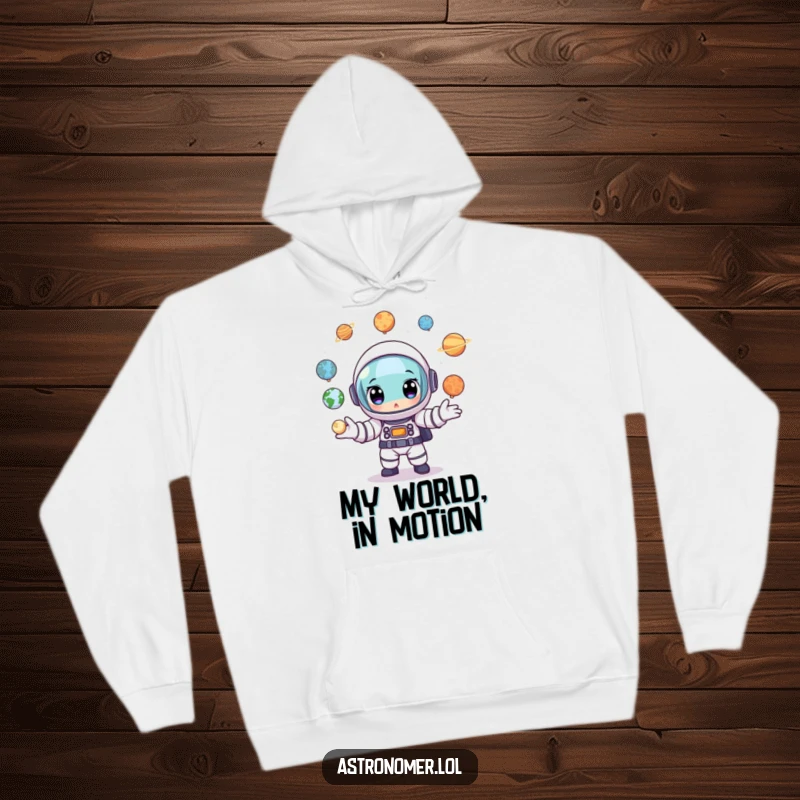 Funny Astronaut Hoodie: A cartoon astronaut with wide, determined eyes juggling several small planet models simultaneously.