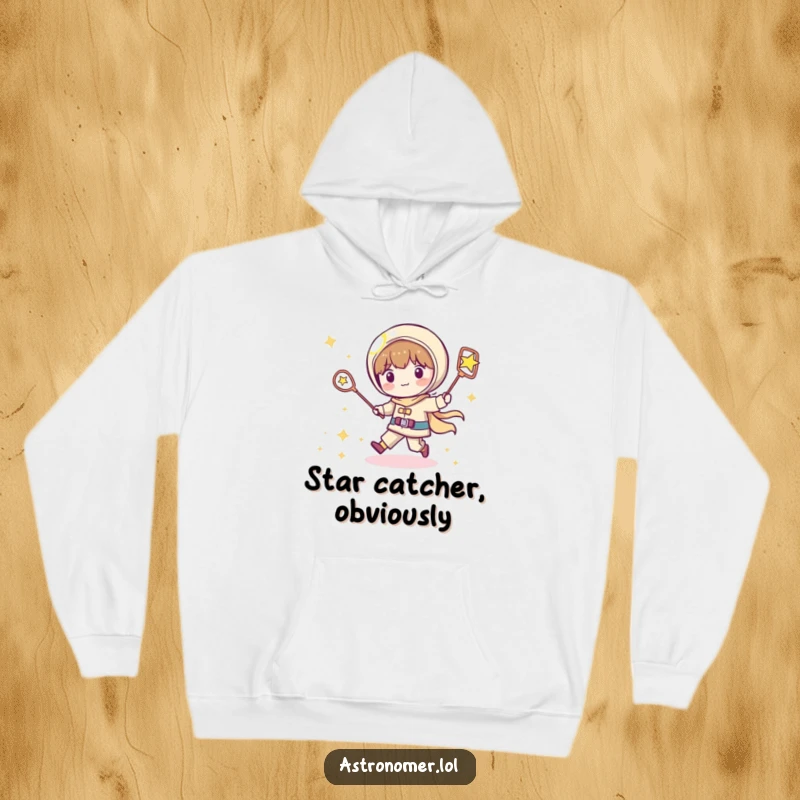 Funny Kawaii astronomer hoodie depicting a playful character chasing a shooting star with a net, offering humorous warmth and style.