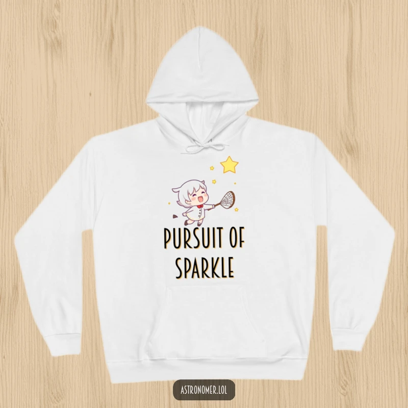 Funny hoodie featuring a gleeful character enthusiastically chasing a shooting star with a net under a starry night sky.