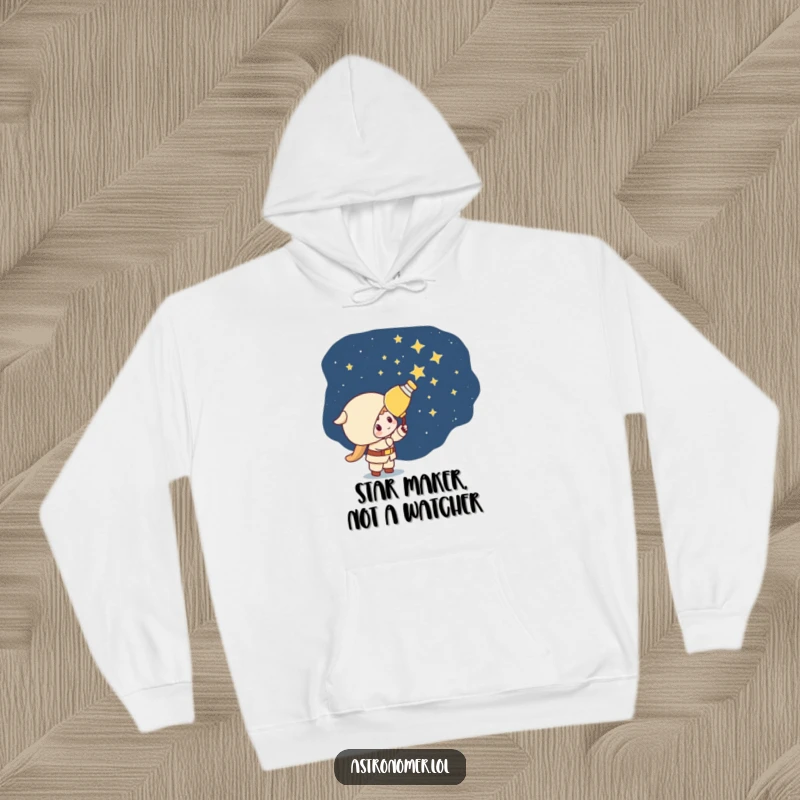 Funny Kawaii astronomer character humorously painting stars onto a dark sky, capturing playful mischief on this cozy hoodie.
