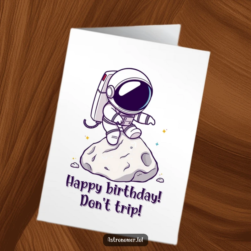 Funny Free Printable Birthday Card: Chibi astronaut comically tripping over a lunar rock, with a goofy expression.