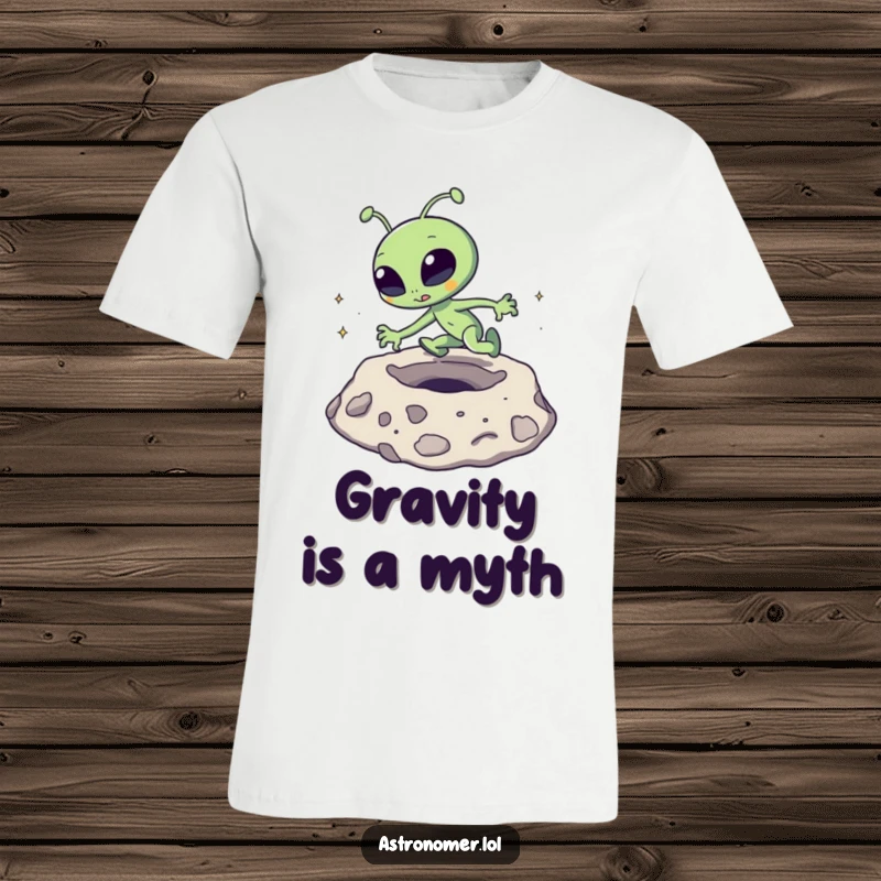 Funny T-Shirt: A goofy alien is caught mid-trip, comically stumbling over a textured moon crater.