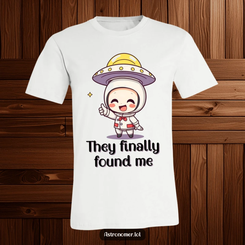 Funny T-Shirt of a character grinning widely while pointing an excited finger at a flying saucer above.