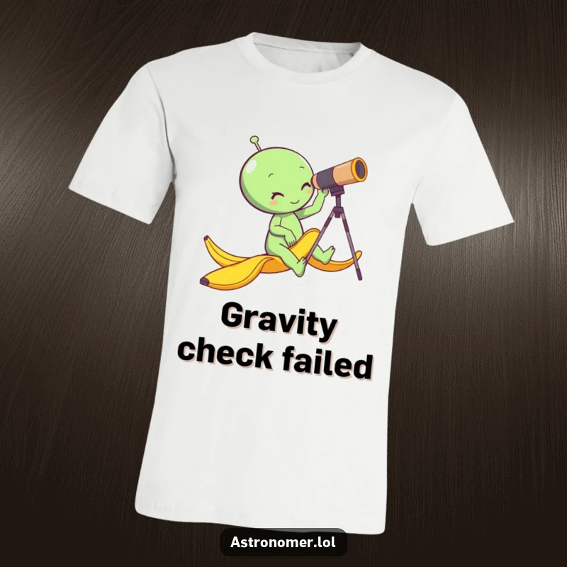 Funny alien slipping on a banana peel while looking through a telescope, cosmic comedy, hilarious space t-shirt.