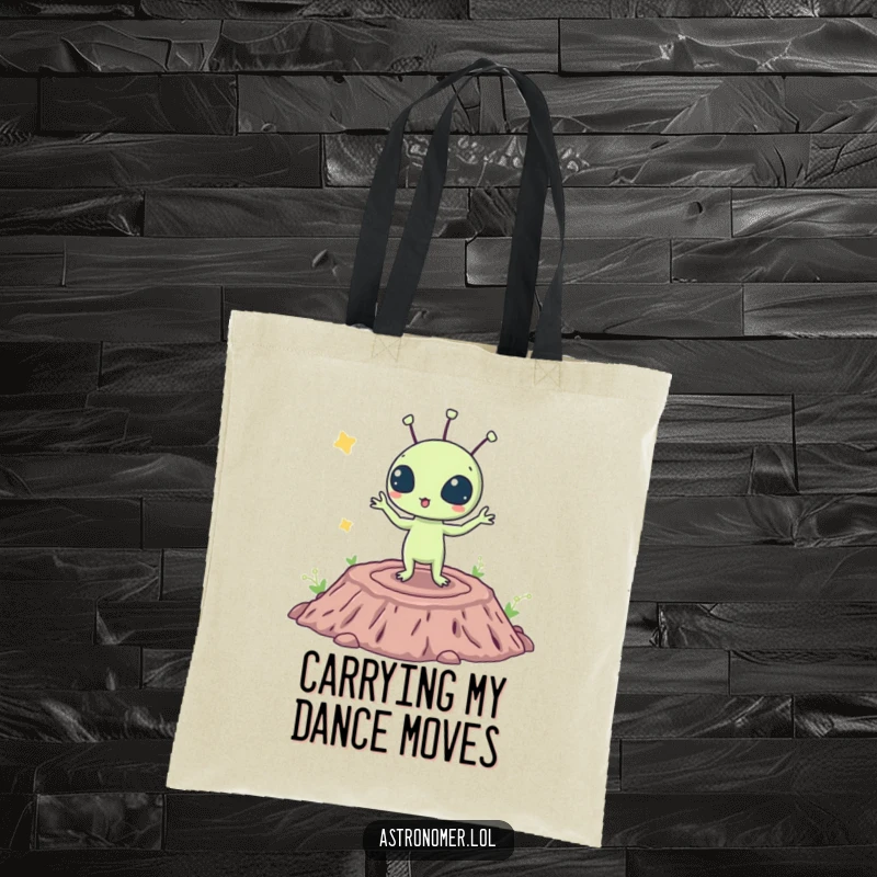Funny tote bag depicting a surprised alien species performing a silly dance on a crater, a fun accessory for space lovers.