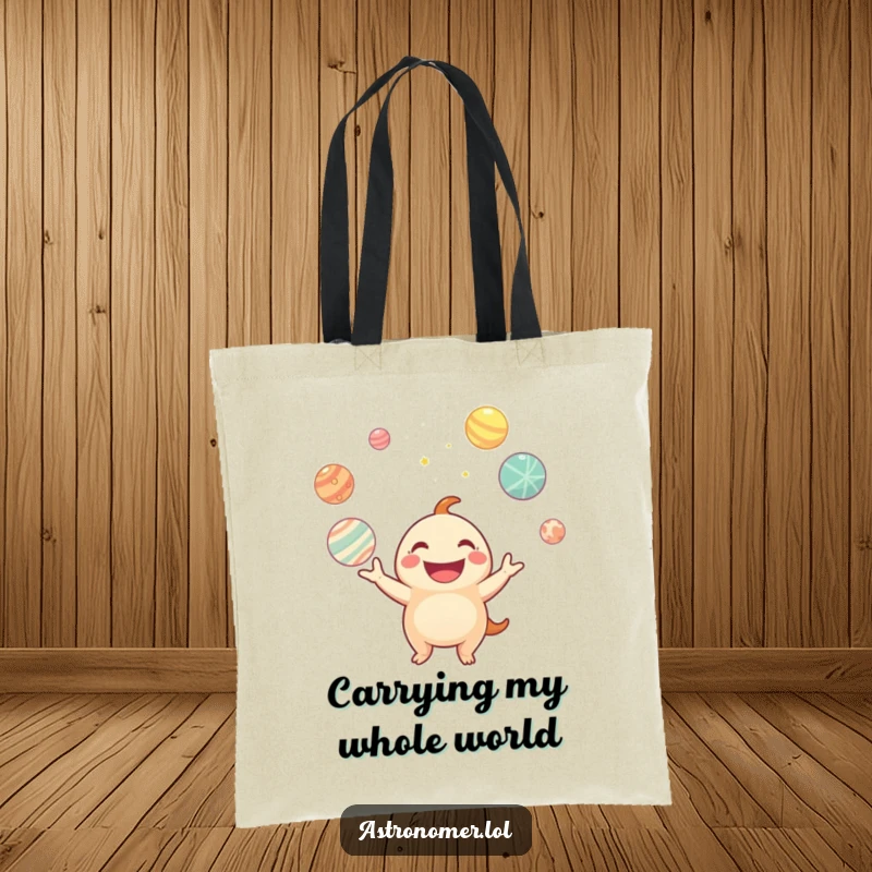 Funny tote bag illustrating a happy creature balancing glowing planets, perfect for carrying daily items with cosmic flair.