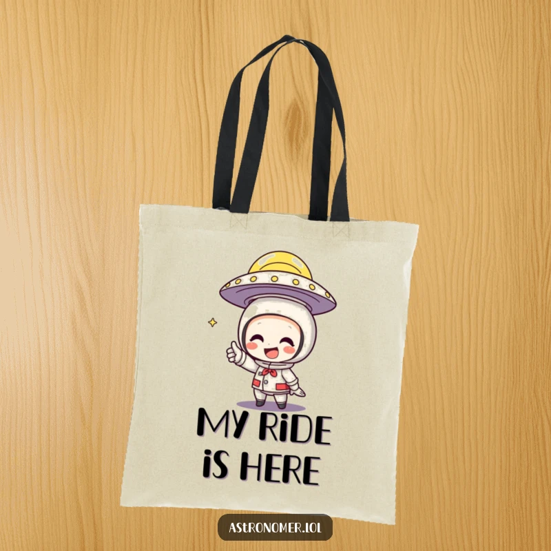 Funny Tote Bag showing a character grinning while pointing at a flying saucer, hinting at alien contact.