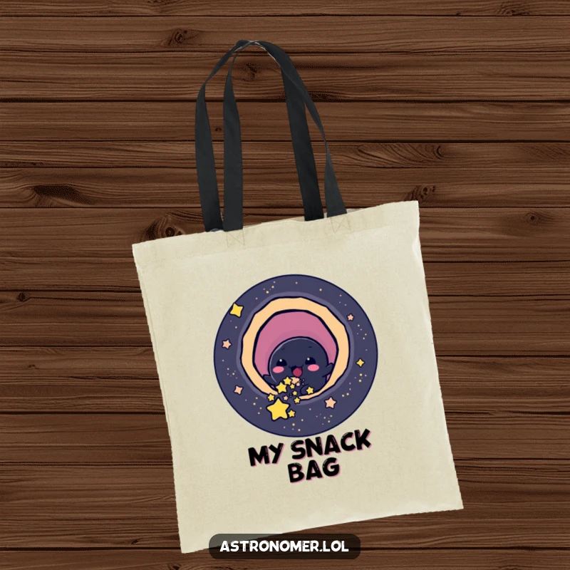 Funny cheerful black hole character playfully slurping up small stars, humorous tote bag for snack enthusiasts.